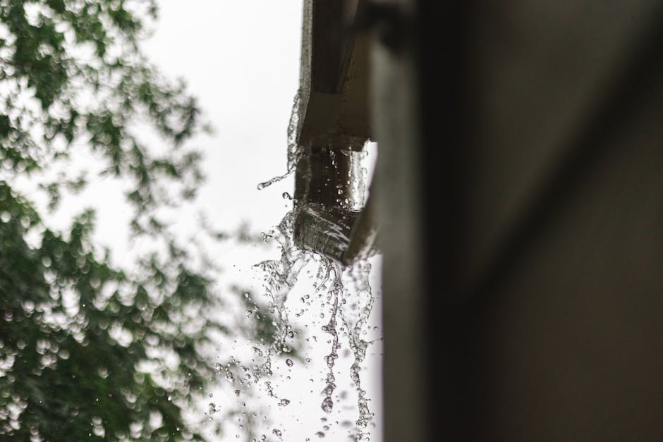 pexels-photo-13307118-13307118-1 Close-up of rainwater pouring from a gutter, captured during a rainfall in Houston.